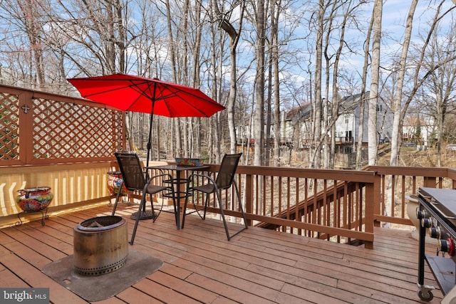 wooden deck featuring outdoor dining area