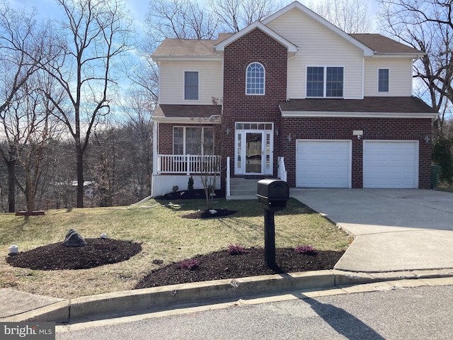 traditional home featuring covered porch, concrete driveway, an attached garage, a front yard, and brick siding