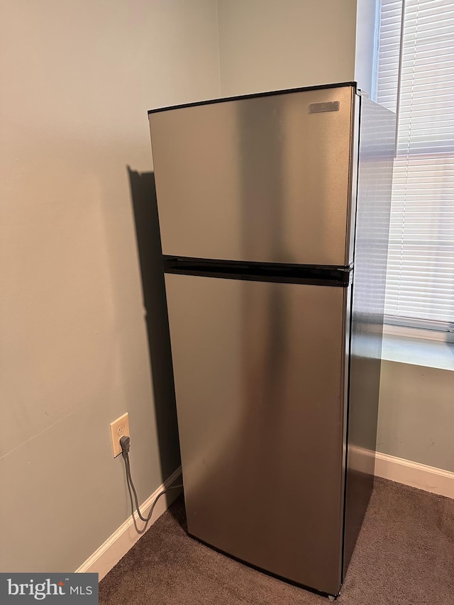 details with carpet flooring, baseboards, and freestanding refrigerator