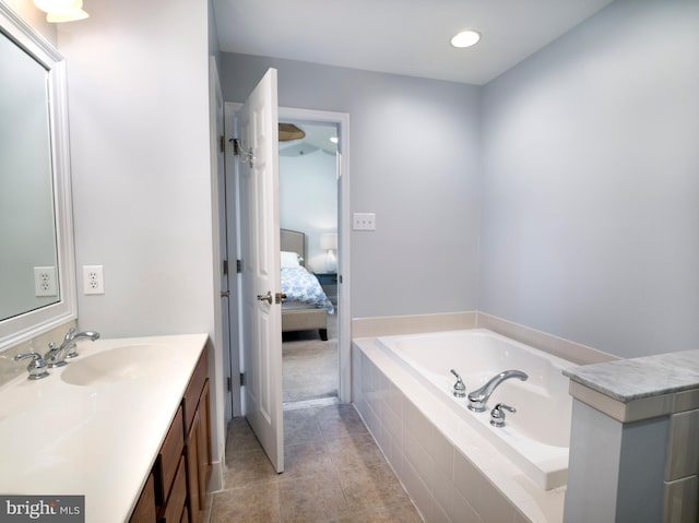 bathroom with vanity, tile patterned floors, a bath, and connected bathroom