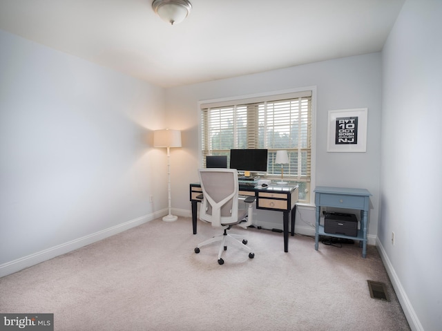 carpeted office space featuring visible vents and baseboards