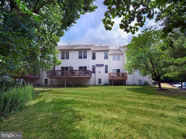 back of house with a lawn and a wooden deck