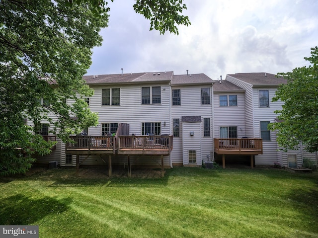 back of property with a wooden deck and a yard