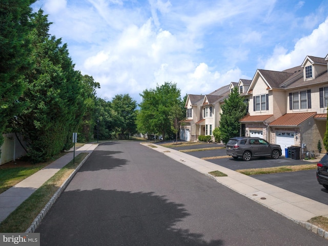 view of road with sidewalks, curbs, and a residential view