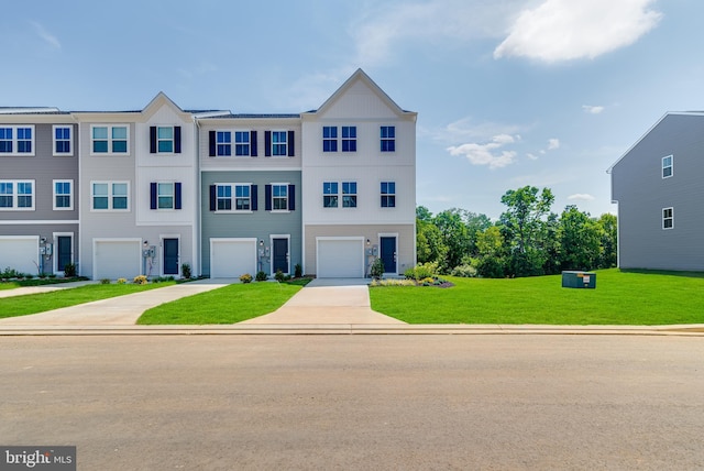 townhome / multi-family property featuring a garage, a front yard, and concrete driveway