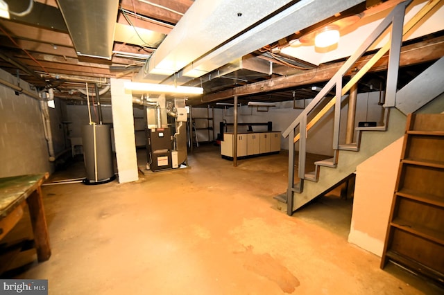 unfinished below grade area featuring stairway, heating unit, and water heater