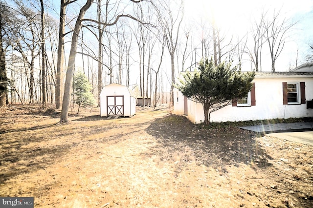 view of yard with a storage shed and an outdoor structure