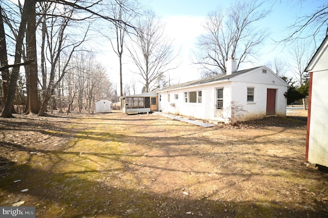 view of yard with an outbuilding and a sunroom