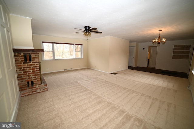 unfurnished living room featuring visible vents, baseboards, light colored carpet, and ceiling fan with notable chandelier