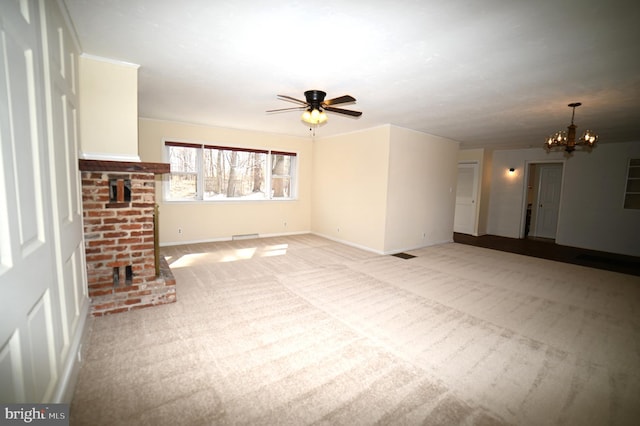 unfurnished living room featuring light colored carpet, a brick fireplace, ceiling fan with notable chandelier, and baseboards