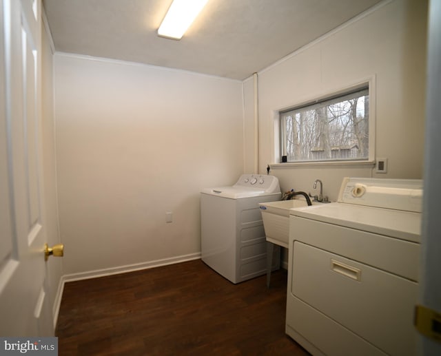 laundry room featuring washer and dryer, a sink, dark wood-style floors, baseboards, and laundry area