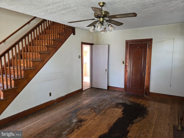 interior space with hardwood / wood-style flooring, baseboards, and a textured ceiling