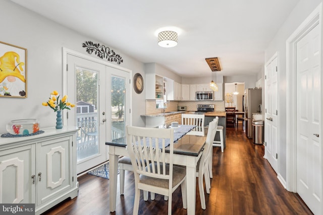 dining room with french doors and dark wood-style floors