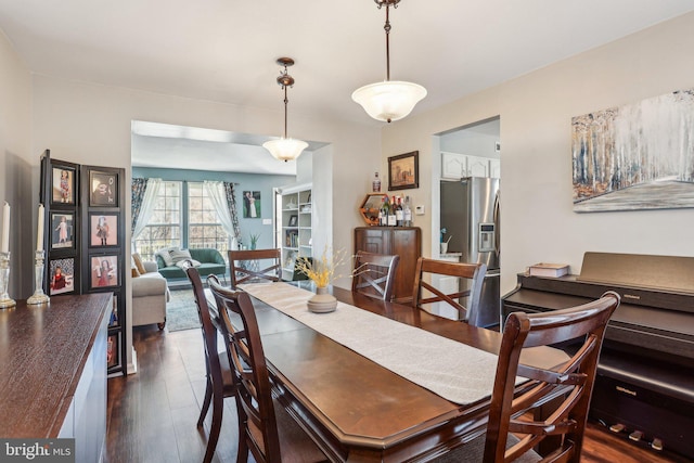 dining area featuring dark wood-style flooring