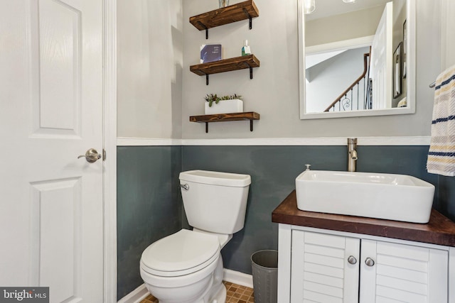 half bath featuring toilet and vanity