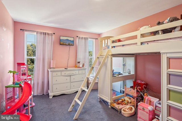 carpeted bedroom with multiple windows