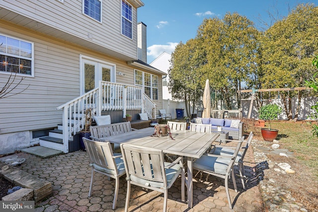 view of patio / terrace with outdoor lounge area, outdoor dining area, fence, and a wooden deck