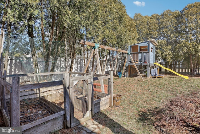 view of yard featuring a playground, an outdoor structure, and fence