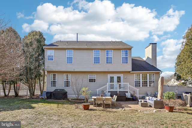 rear view of house with a lawn, a chimney, outdoor lounge area, a fenced backyard, and a patio