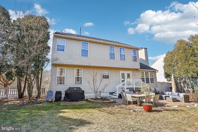 rear view of property featuring an outdoor living space, a lawn, fence, and a patio