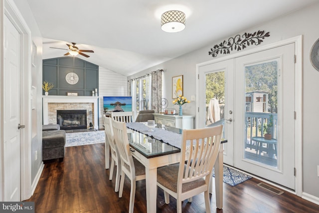 dining room featuring vaulted ceiling, wood finished floors, visible vents, and french doors