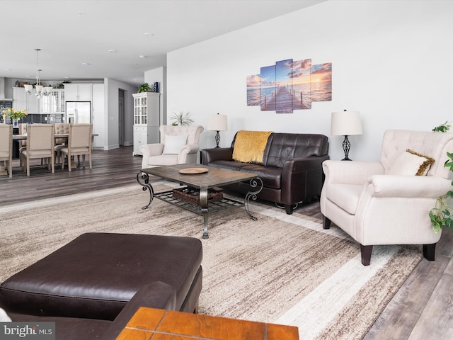 living area featuring a chandelier and wood finished floors