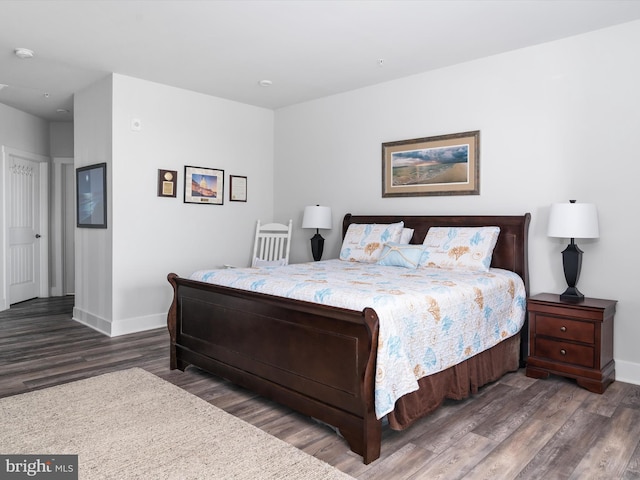 bedroom featuring wood finished floors and baseboards