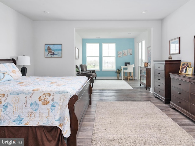 bedroom featuring baseboards and wood finished floors