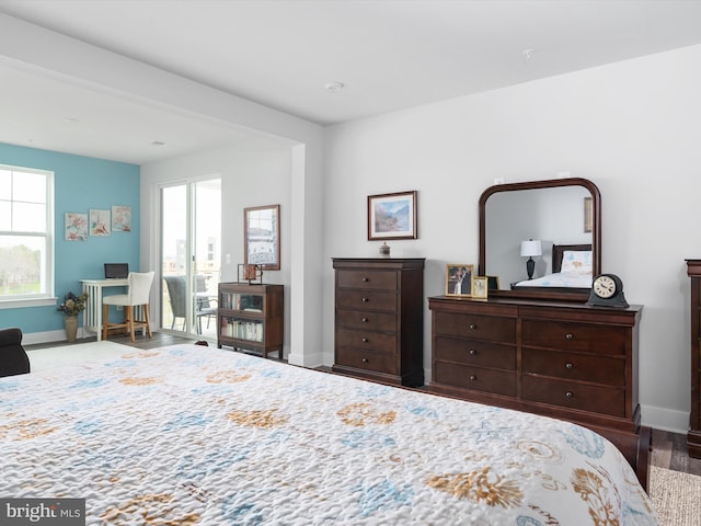 bedroom featuring baseboards and wood finished floors