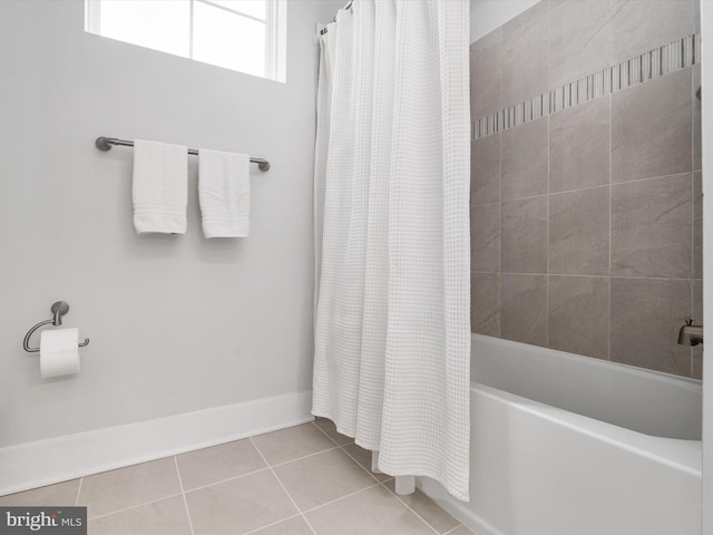 full bath with shower / bath combo, baseboards, and tile patterned floors