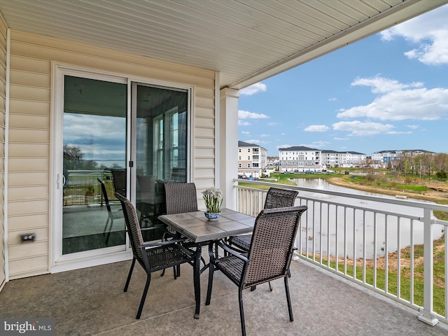 balcony featuring a water view and a sunroom