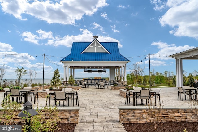 view of patio / terrace with outdoor dining area and a gazebo