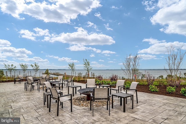 view of patio / terrace featuring a water view and an outdoor fire pit