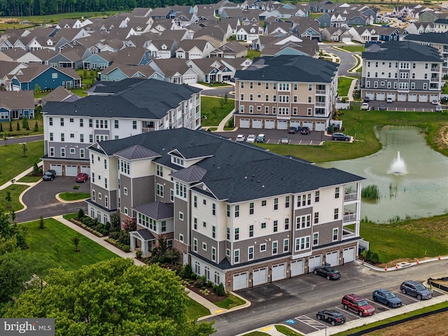 bird's eye view featuring a water view and a residential view