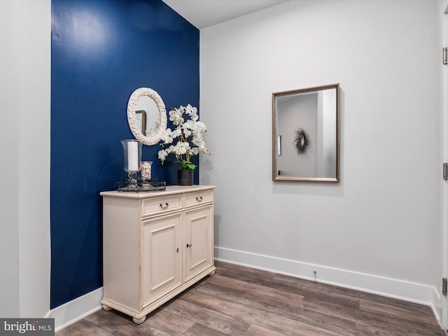 room details with baseboards and wood finished floors