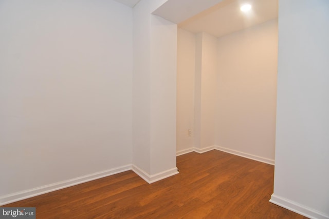 empty room with baseboards and dark wood-style flooring