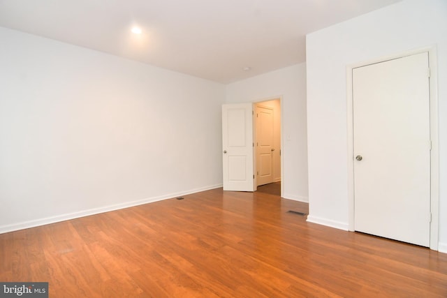 unfurnished bedroom with baseboards and wood finished floors