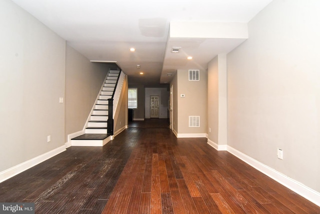 foyer featuring visible vents, hardwood / wood-style flooring, and stairway