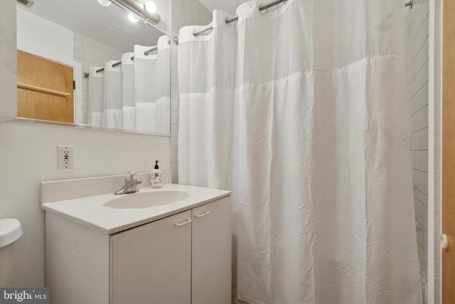 bathroom with vanity and a shower with shower curtain