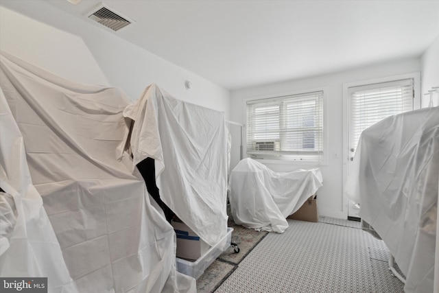 bathroom with a stall shower and visible vents