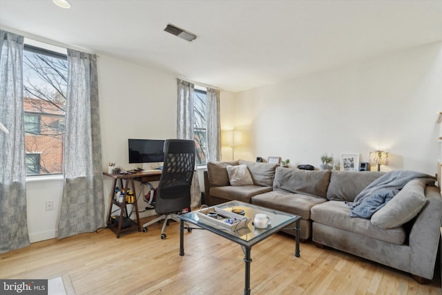 living room with wood finished floors and visible vents