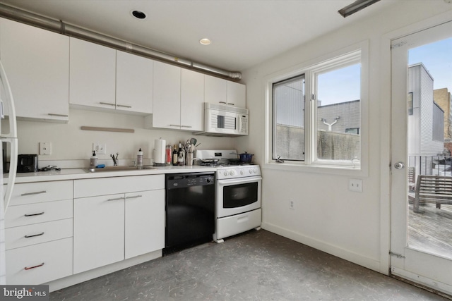 kitchen with white appliances, a sink, white cabinets, baseboards, and light countertops