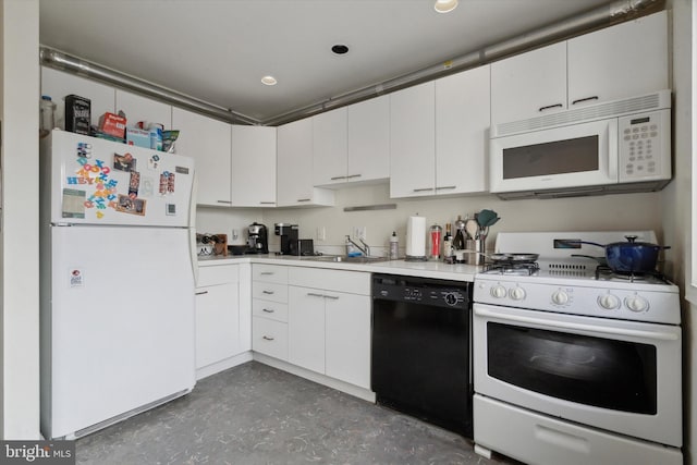 kitchen with white cabinets, white appliances, light countertops, and a sink