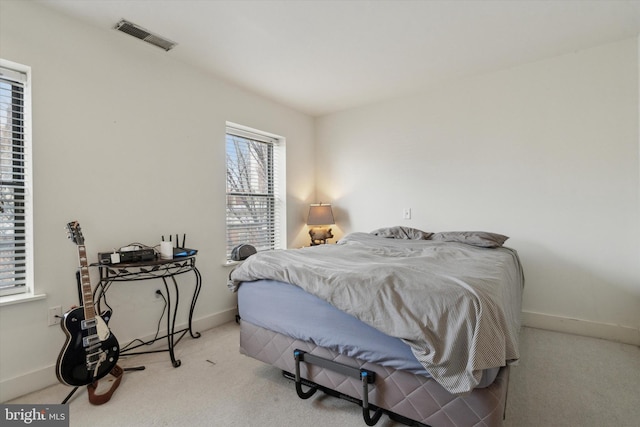 carpeted bedroom featuring visible vents and baseboards