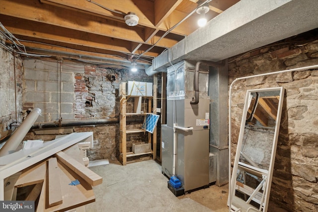 unfinished basement featuring heating unit