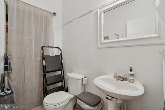 bathroom featuring toilet and a sink