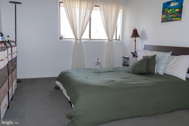 bedroom featuring carpet and baseboards