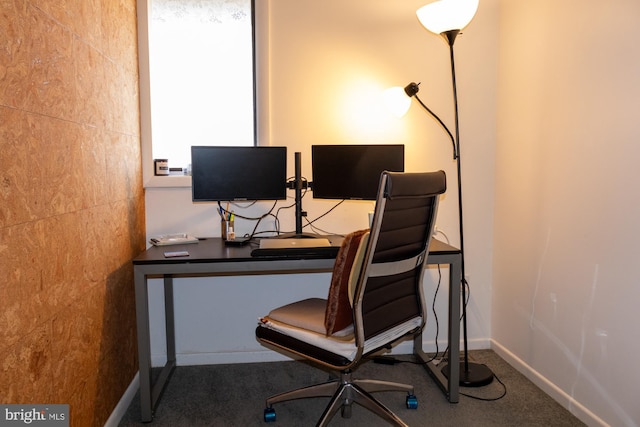 carpeted office featuring baseboards