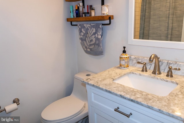 bathroom featuring vanity and toilet