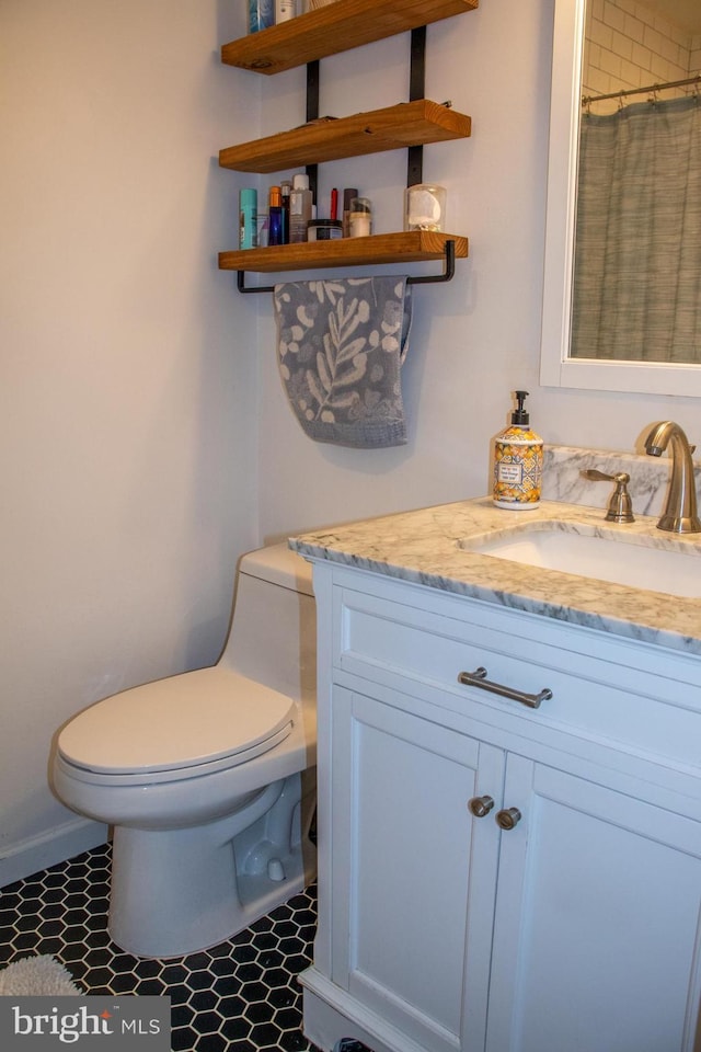 full bathroom with toilet, curtained shower, vanity, and tile patterned floors